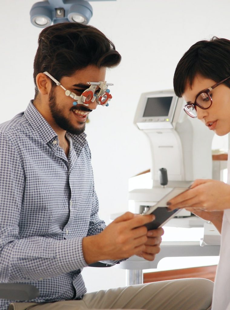 Woman doing eye test with optometrist in eye sight clinic